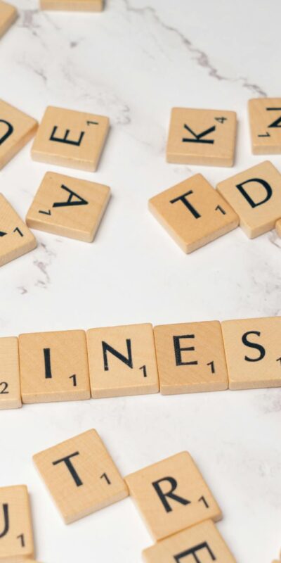 Scrabble tiles arranged to spell 'Online Shop' on marble background for an e-commerce concept.
