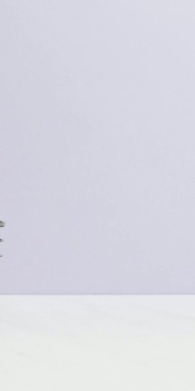 Shopping cart filled with cash on a plain background, ideal for finance and retail themes.